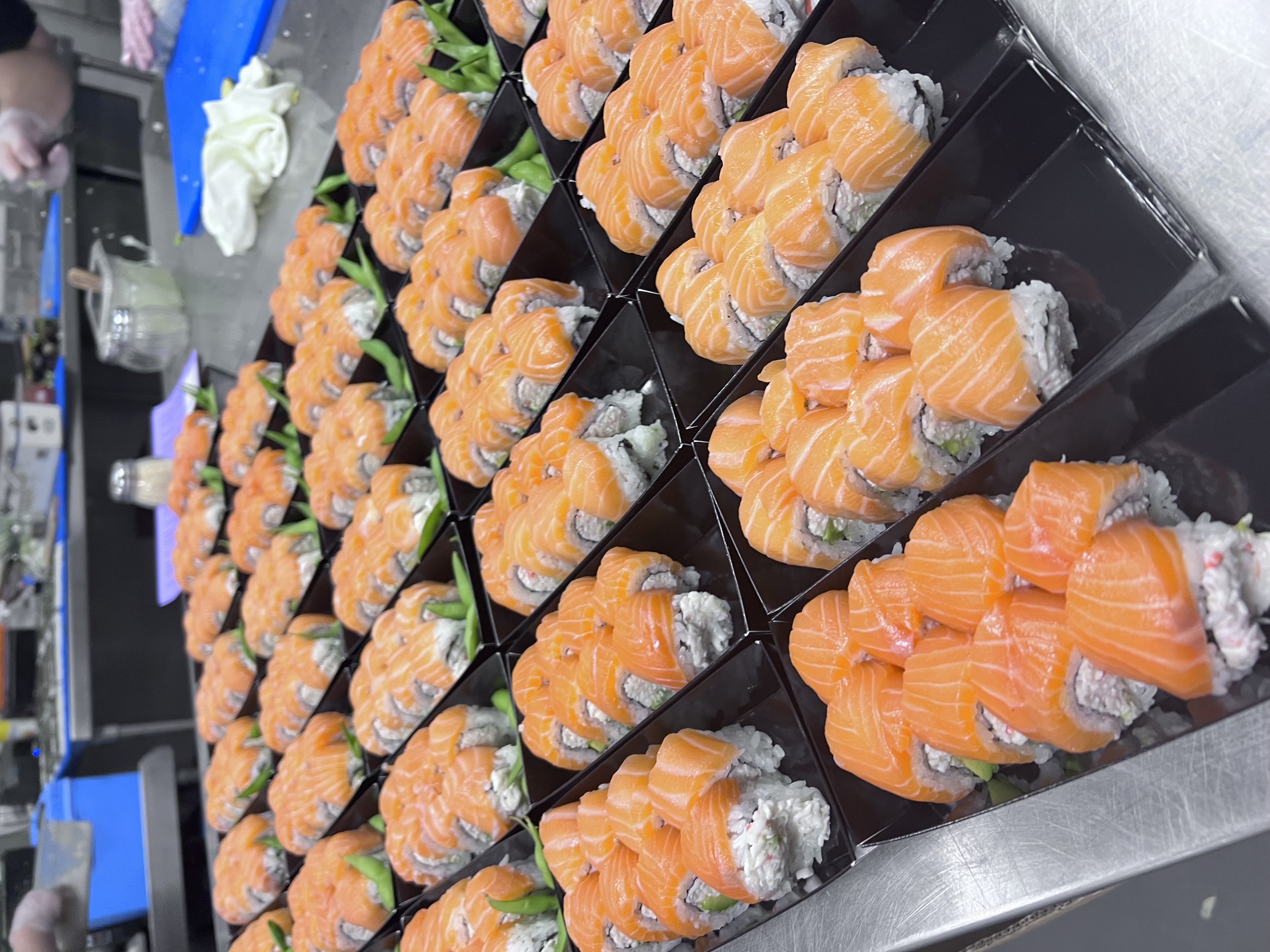 Diverse tech team sharing a catered lunch in a modern office